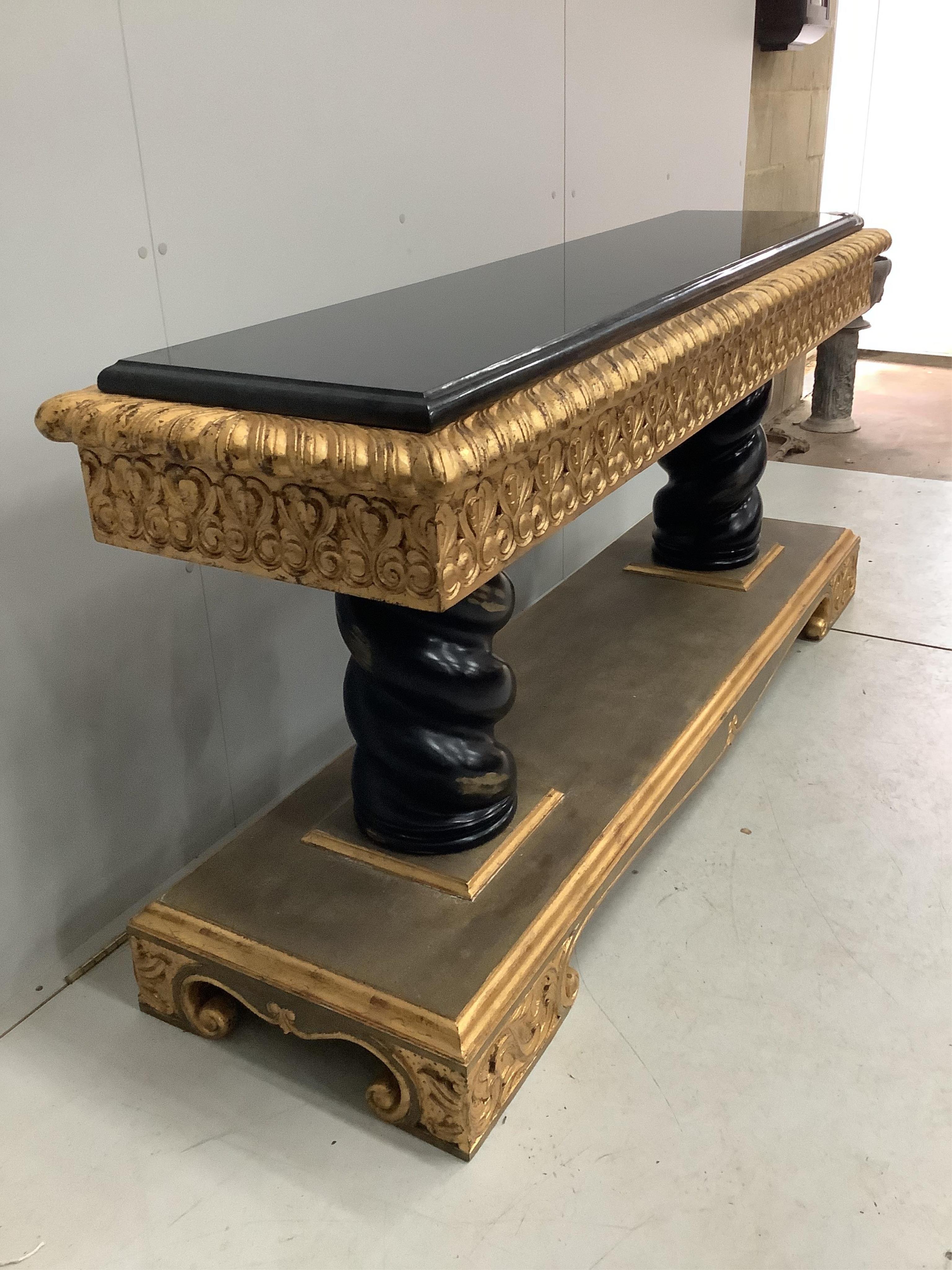 A Harrison Gil parcel gilt console table with marble inset top, width 180cm, depth 51cm, height 85cm and matching ornate wall mirror, width 138cm, height 165cm. Condition - fair to good, some minor chipping